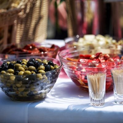 Bowls of olive and other colourful food set out for a buffet event